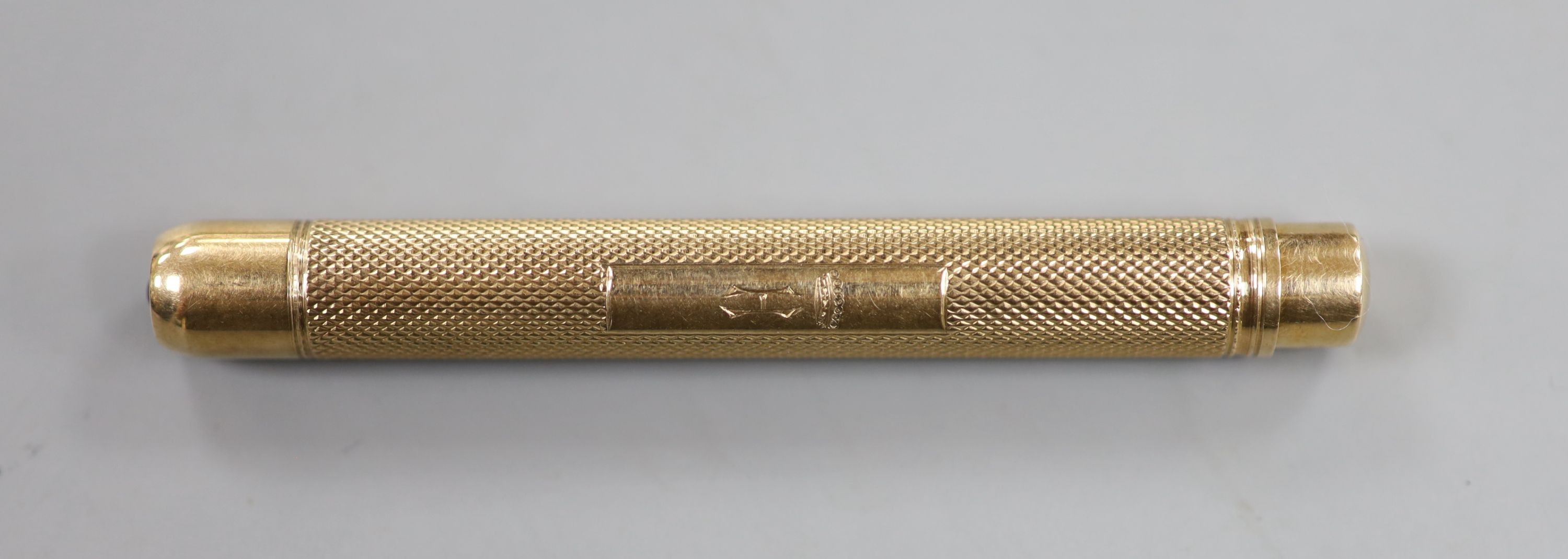 A 1950's engine turned 9ct gold pencil, maker, EB, London, 1956, 78mm, gross 19.2 grams.
